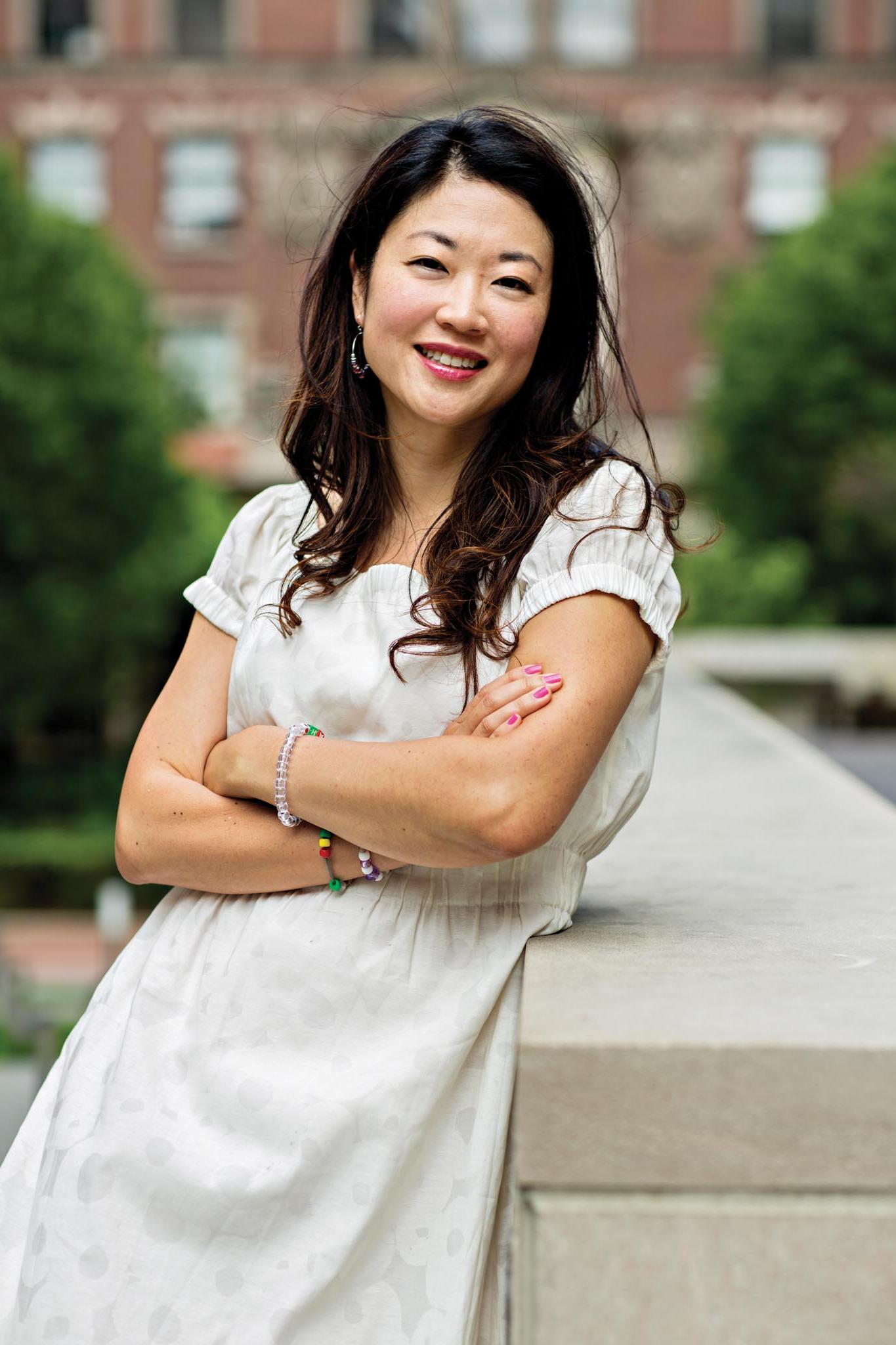 Sooji Park headshot on campus. She is wearing a white dress and has her arms crossed