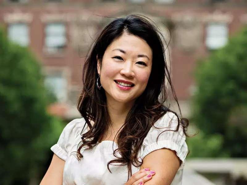 Sooji Park headshot on campus. She is wearing a white dress and has her arms crossed